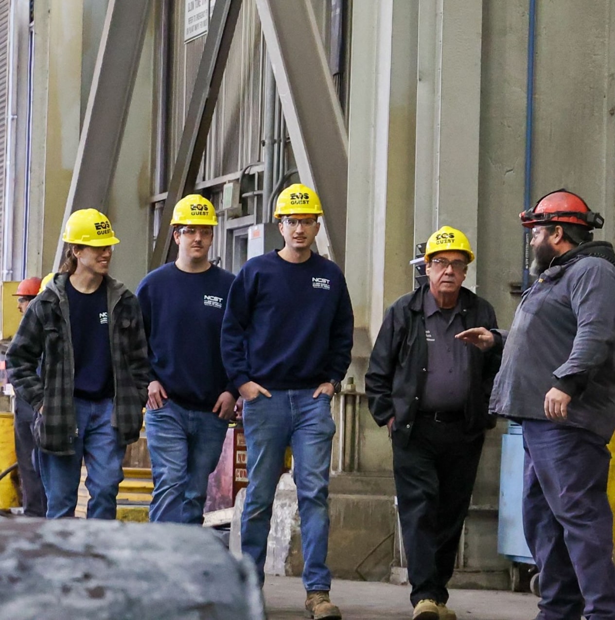 Students walking wearing hardhats